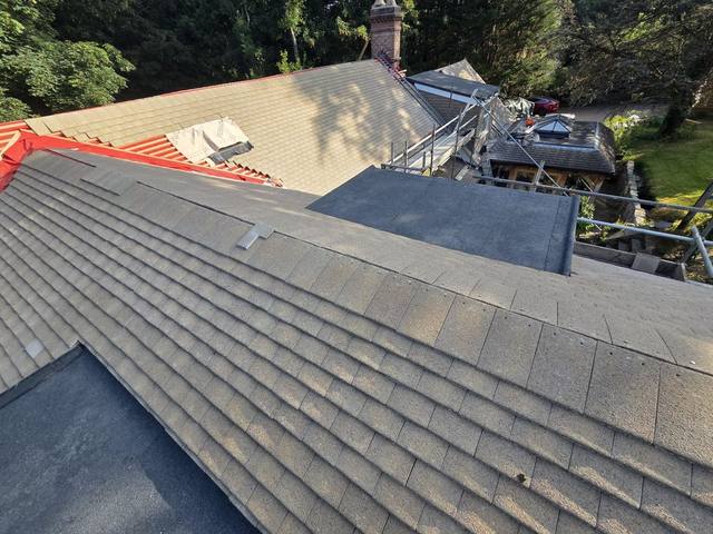 New tiles and flat-roof detail completed at the valley — PGA Installations roofing project