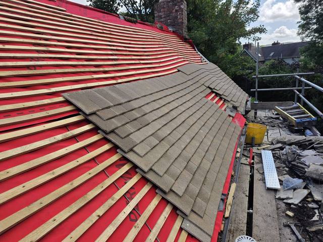 New tiles being laid over fresh membrane and battens