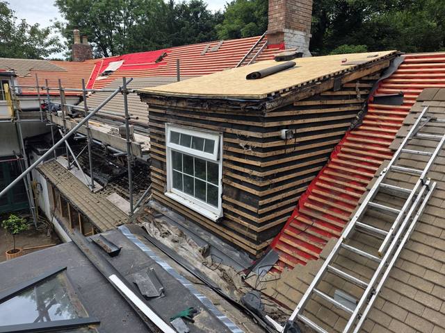 Dormer mid-transformation — old boards off, new deck on — PGA Installations roofing project