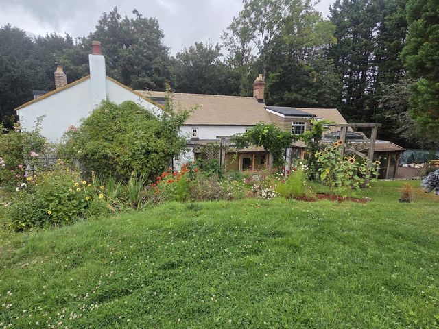 Finished cottage with completed new roof — PGA Installations roofing project
