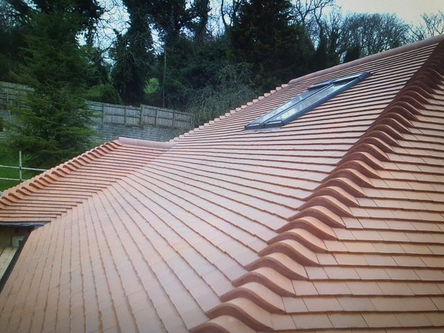 Completed red plain-tile roof with rooflight — PGA Installations roofing project